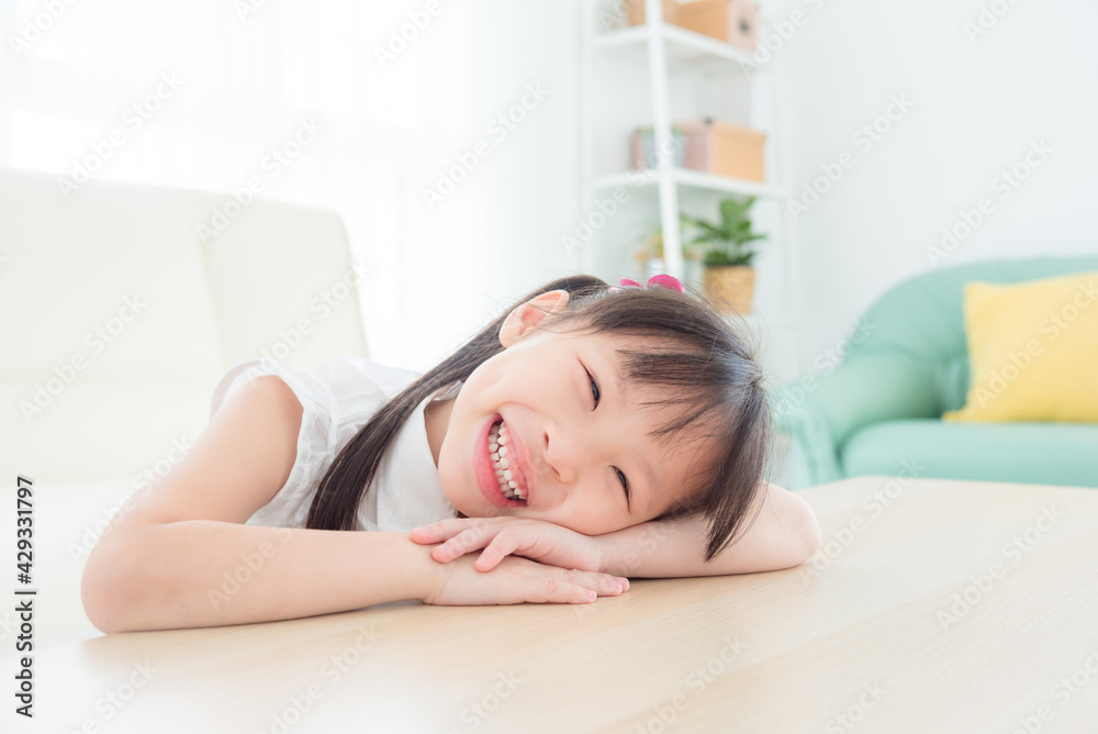 Little asian girl smiling happily in living room . Little asian girl smiling happily in living room .