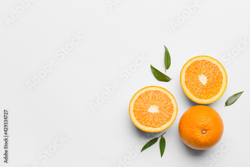 Fototapeta Naklejka Na Ścianę i Meble -  Fresh oranges with green leaves on white background