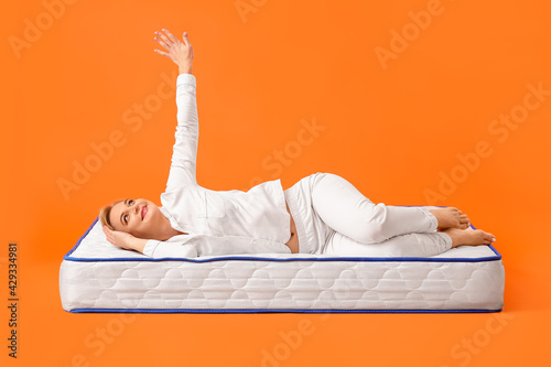 Mature woman lying on soft ...