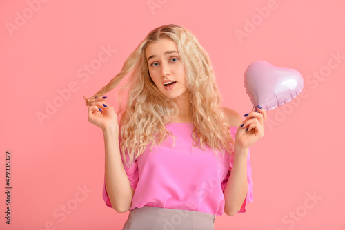 Young blonde woman holding ...