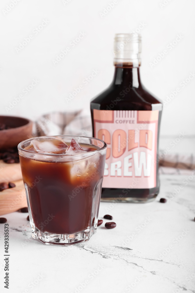 Composition with tasty cold brew and coffee beans on light background Composition with tasty cold brew and coffee beans on light background