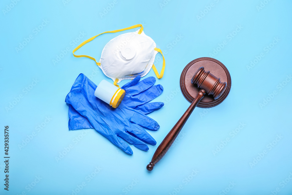 Judge gavel, mask, pills and gloves on color background. Concept of health care reform Judge gavel, mask, pills and gloves on color background. Concept of health care reform