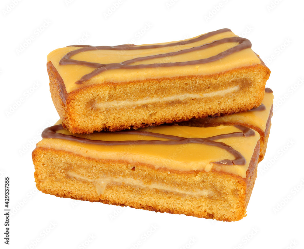 Caramel flavour sponge cake slices topped with salted caramel icing isolated on a white background Caramel flavour sponge cake slices topped with salted caramel icing isolated on a white background