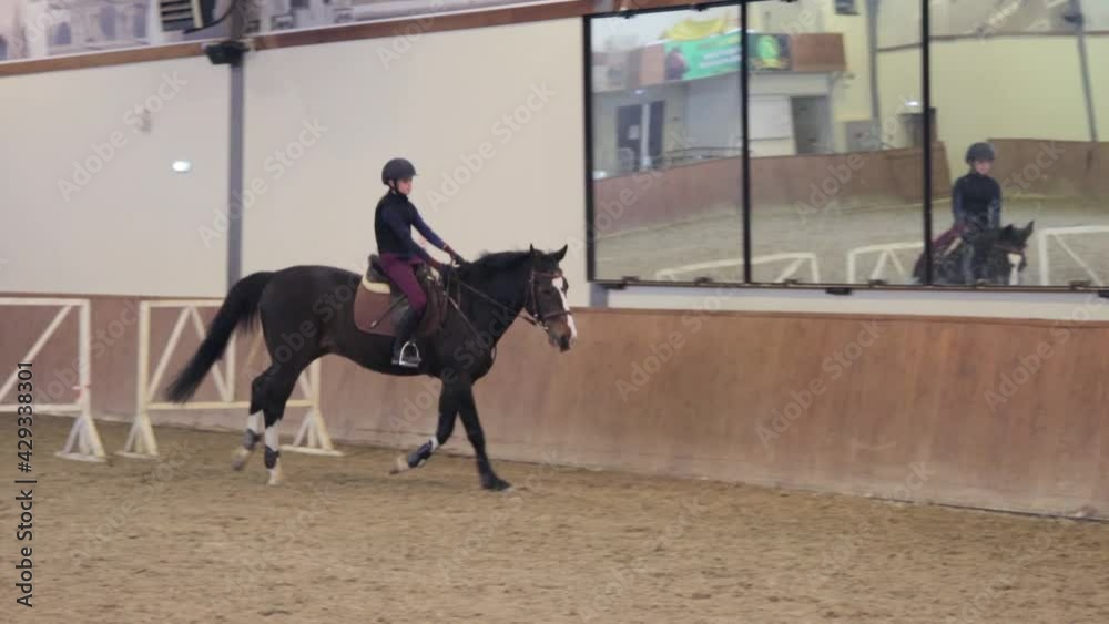 Girl riding her horse on hippodrome Girl riding her horse on hippodrome