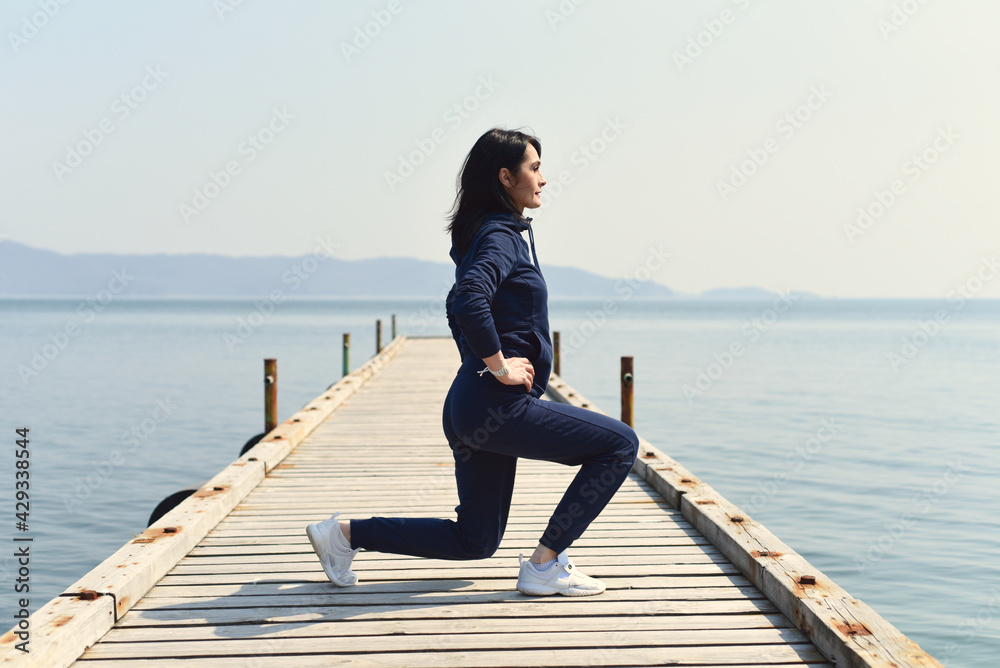 45 y.o. Russian woman squatting on a wooden pier by the Japanese sea 45 y.o. Russian woman squatting on a wooden pier by the Japanese sea