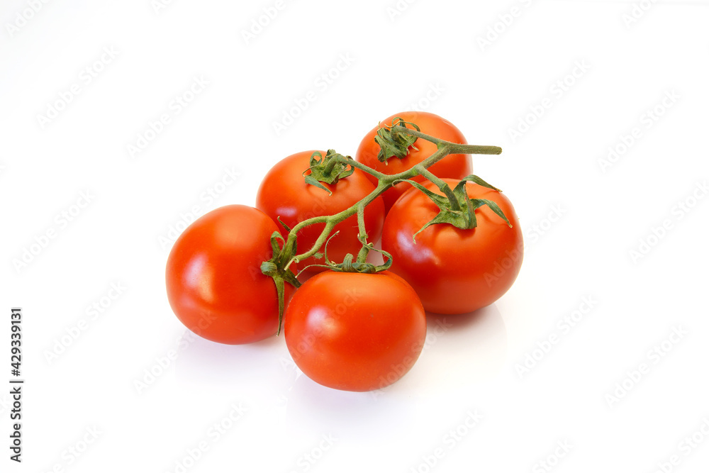 Red tomatoes on a branch on a white background.