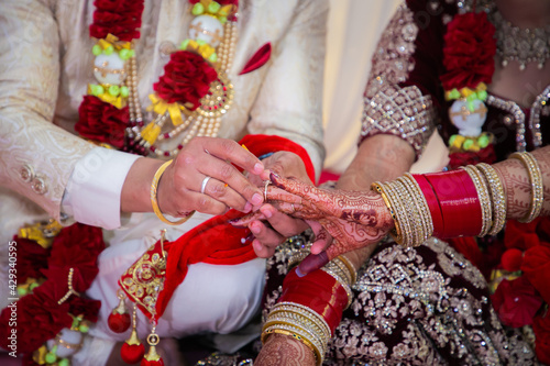 Indian Punjabi wedding ceremony doli and pani varna, ritual items and hands close up