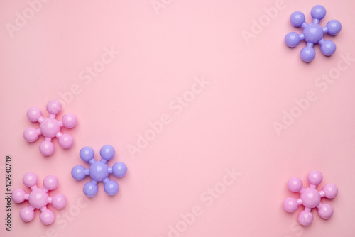 Baby kid toy purple molecula model constructor isolated on the pastel pink background © KatrinaEra
