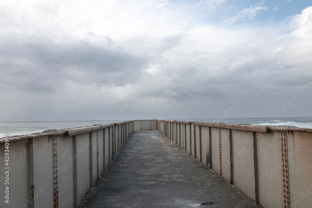 Metal Pedestrian Bridge with the Sea as a Backdrop Metal Pedestrian Bridge with the Sea as a Backdrop