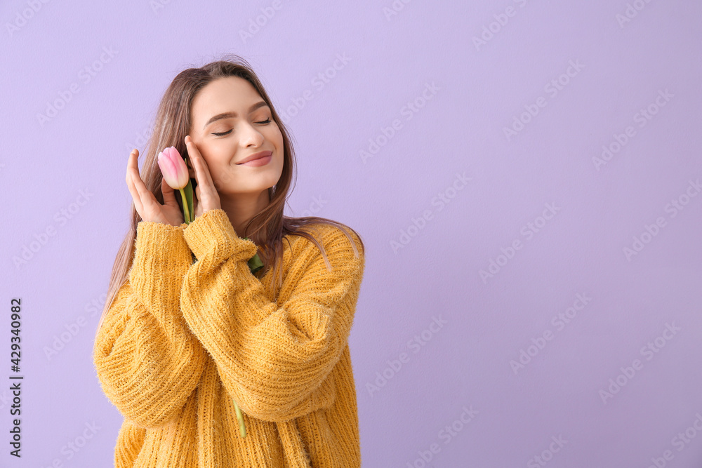 Happy young woman with beautiful tulip on color background Happy young woman with beautiful tulip on color background