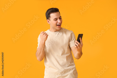 Happy young man with mobile...