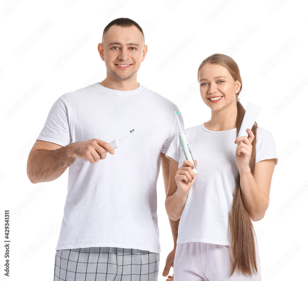 Young couple brushing teeth on white background Young couple brushing teeth on white background
