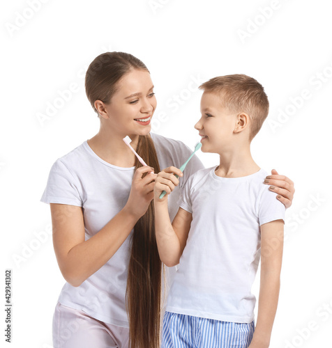 Mother and little son brush...