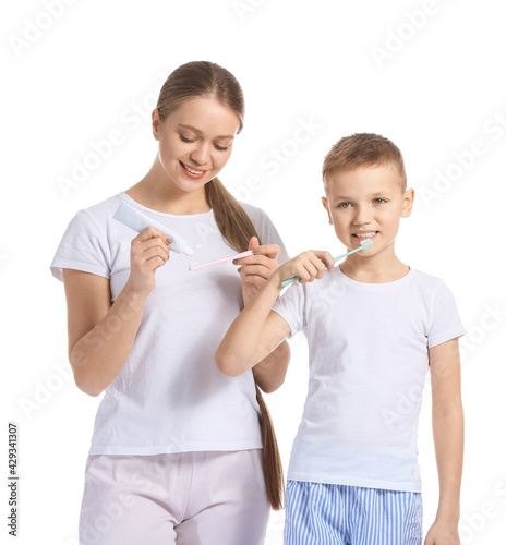 Mother and little son brush...