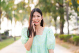 Portrait of asian beautiful women talking on smartphone in outdoor park