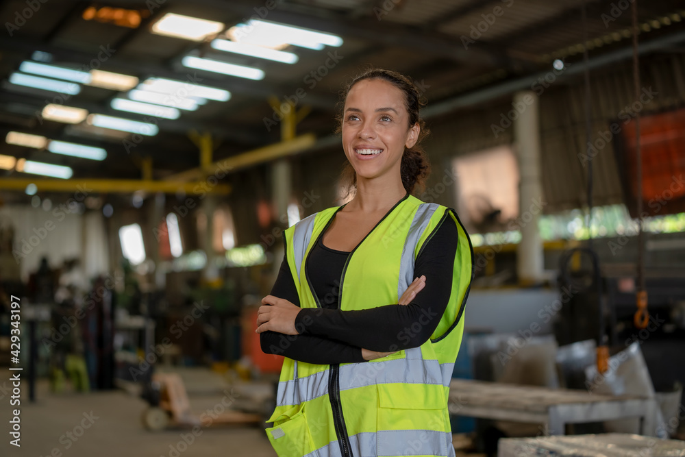 Portrait of industrial woman engineer at work in a factory,Arms crossed. Portrait of industrial woman engineer at work in a factory,Arms crossed.