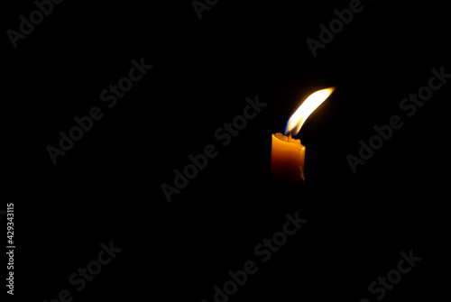 Lighted candle on a dark background, Light a candle for religious ceremony
