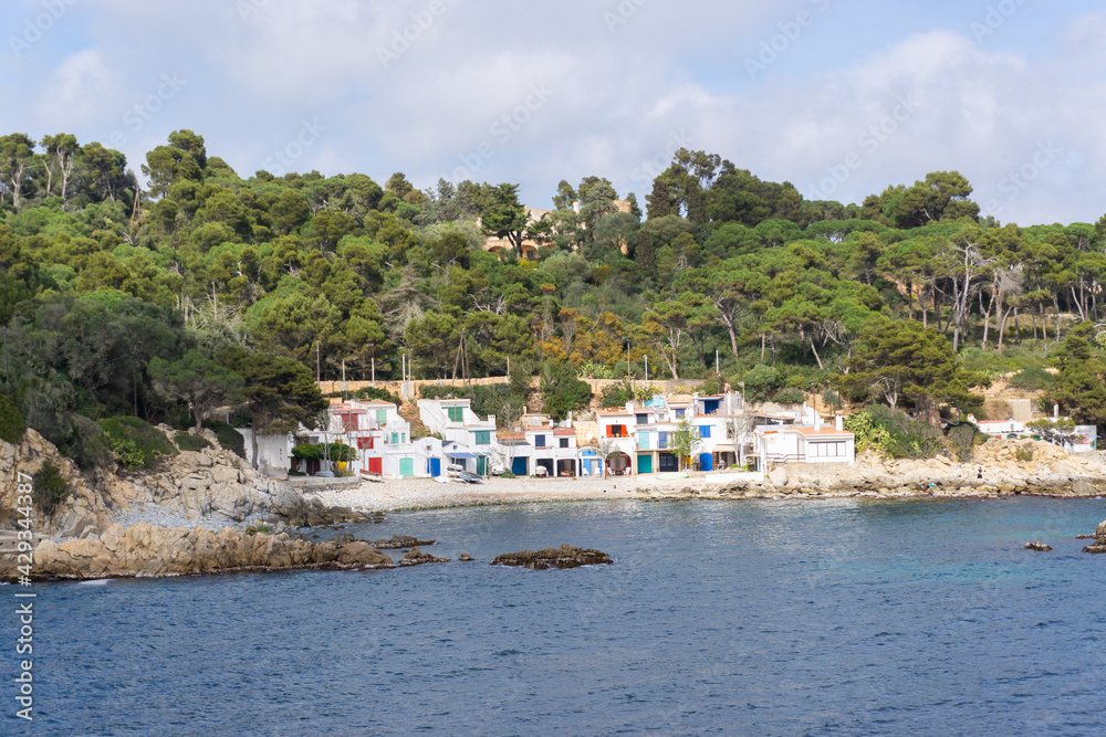View of the small cove Cala S'Alguer with its fishermen's houses of different colors in COSTA BRAVA