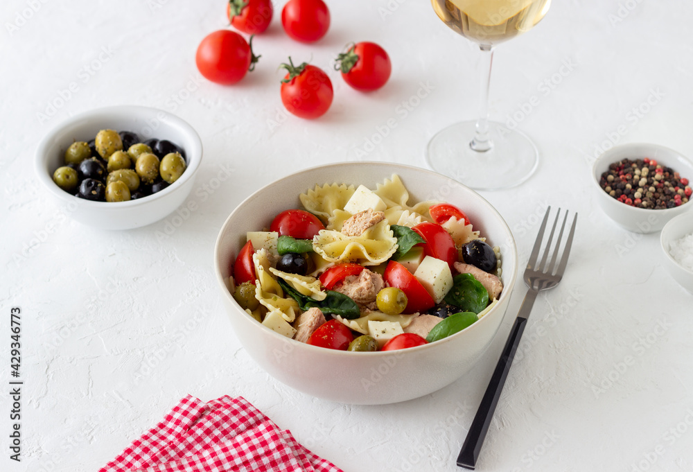 Pasta salad with tuna, tomatoes and white cheese. Farfalle. Healthy eating. Diet.