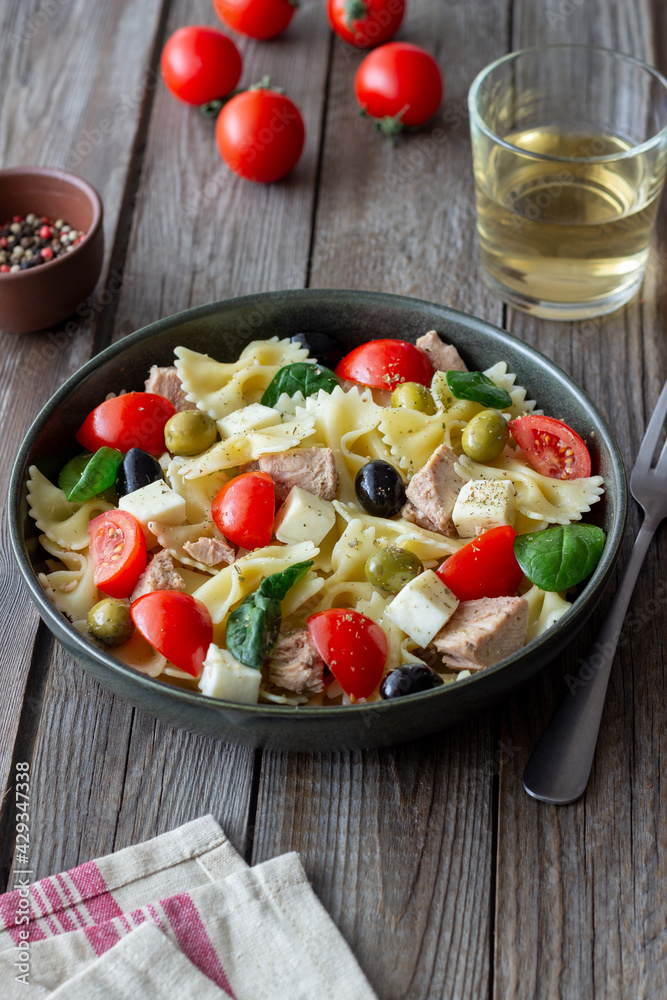 Pasta salad with tuna, tomatoes and white cheese. Farfalle. Healthy eating. Diet. Pasta salad with tuna, tomatoes and white cheese. Farfalle. Healthy eating. Diet.