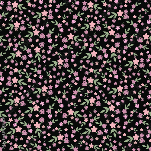 Seamless floral pattern in vector on a black background.  © Larisa
