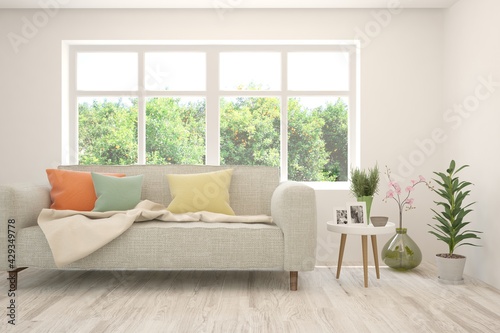 White living room with sofa and summer landscape in window. Scandinavian interior design. 3D illustration