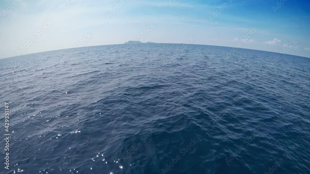 Helicopter flight over the ocean surface. Skyline, seascape.
