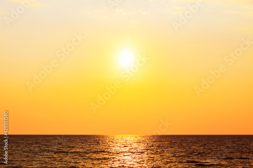 Sundown over the sea . Follow the sun . Sun over the open sea in the evening 