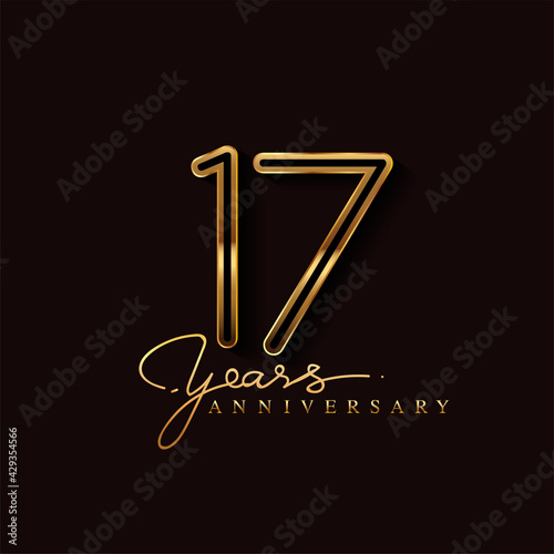 17 Years Anniversary Logo Golden Colored isolated on black background, vector design for greeting card and invitation card photo