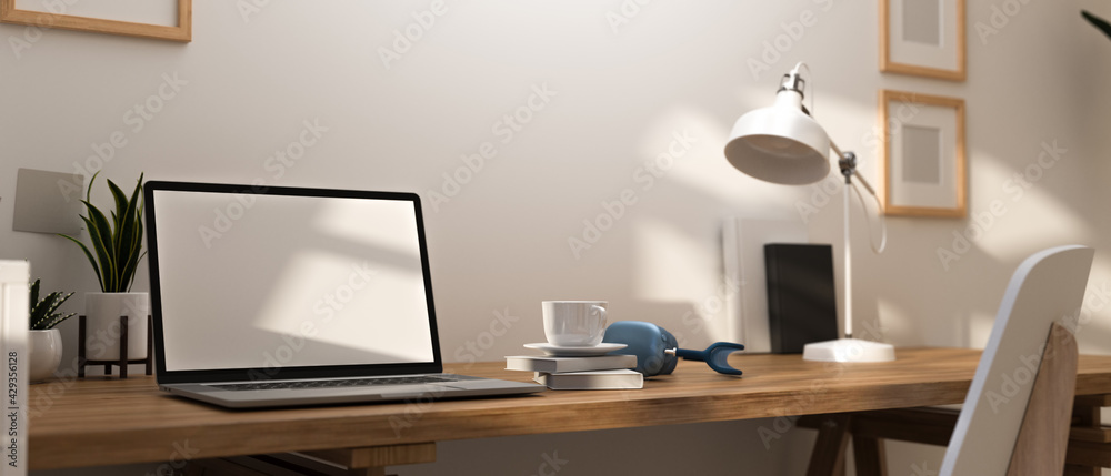3D rendering, home office room with working table, mock up laptop and decorations on wooden desk 3D rendering, home office room with working table, mock up laptop and decorations on wooden desk
