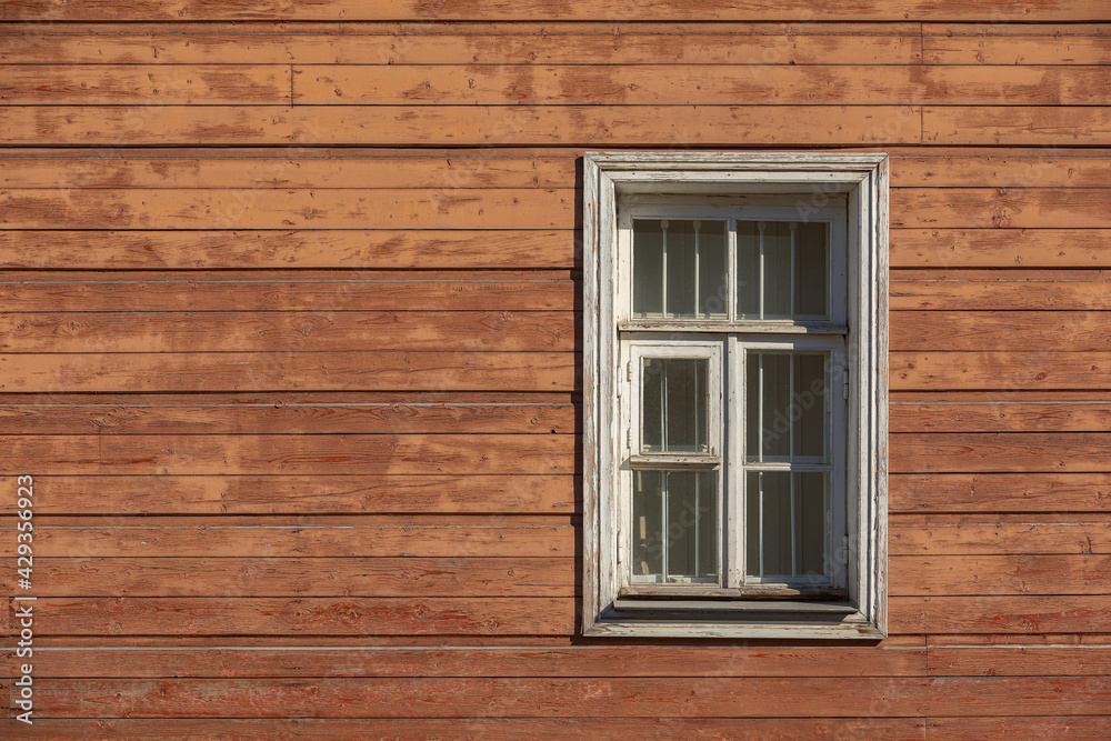 Old and shabby wall of wooden house with the window. Old and shabby wall of wooden house with the window.