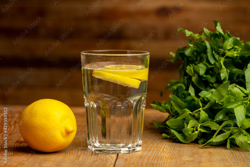 Water with sliced lemon on wooden background Water with sliced lemon on wooden background