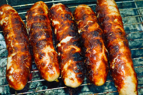 close-up - delicious grilled sausages with appetizing crust
