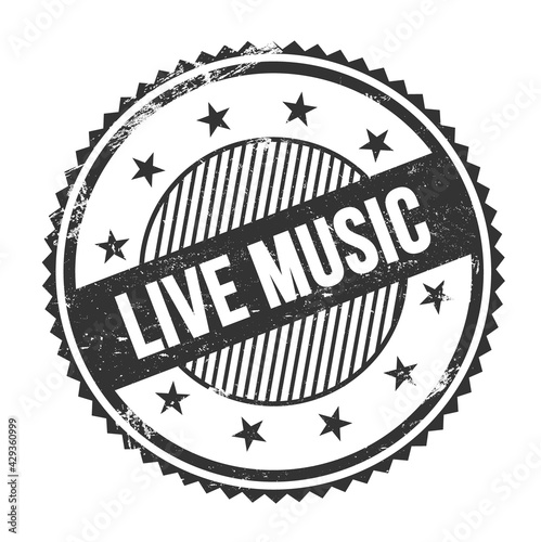 LIVE MUSIC text written on black grungy round stamp.