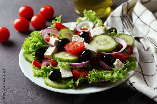 Plate of greek salad on dark wooden background