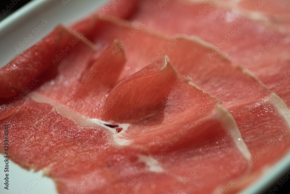 Raw freshly prepared sliced beef for hot pot and Japanese sukiyaki Raw freshly prepared sliced beef for hot pot and Japanese sukiyaki