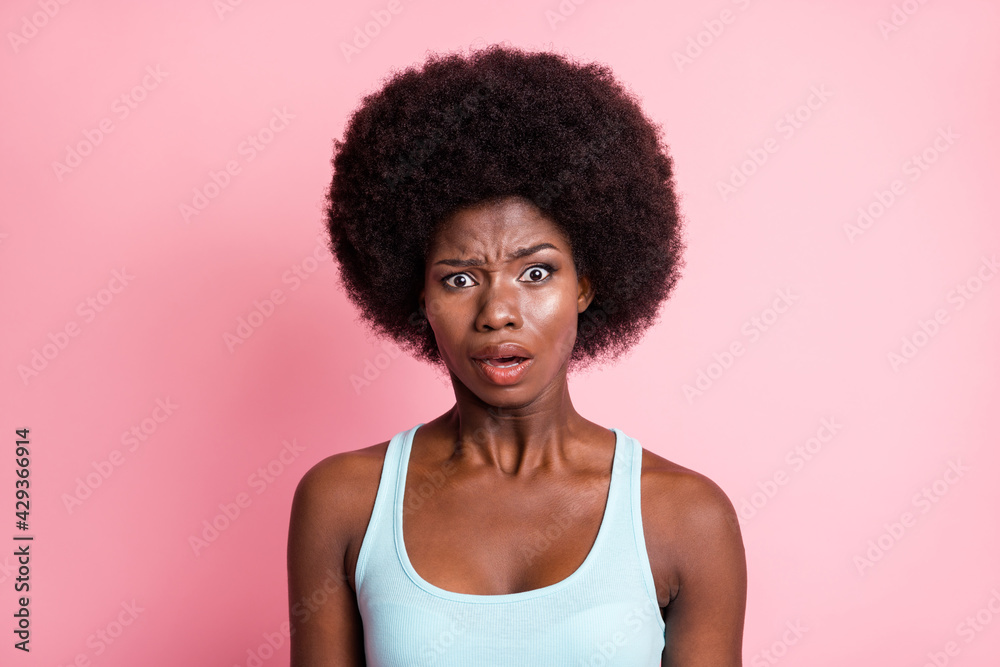 Portrait of stressed brunette curly lady wear blue top isolated on pink color background Portrait of stressed brunette curly lady wear blue top isolated on pink color background
