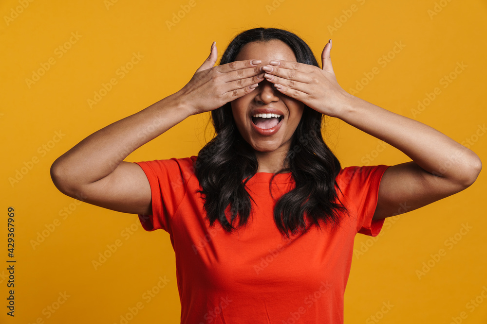 Young black happy woman smiling and covering her eyes Young black happy woman smiling and covering her eyes