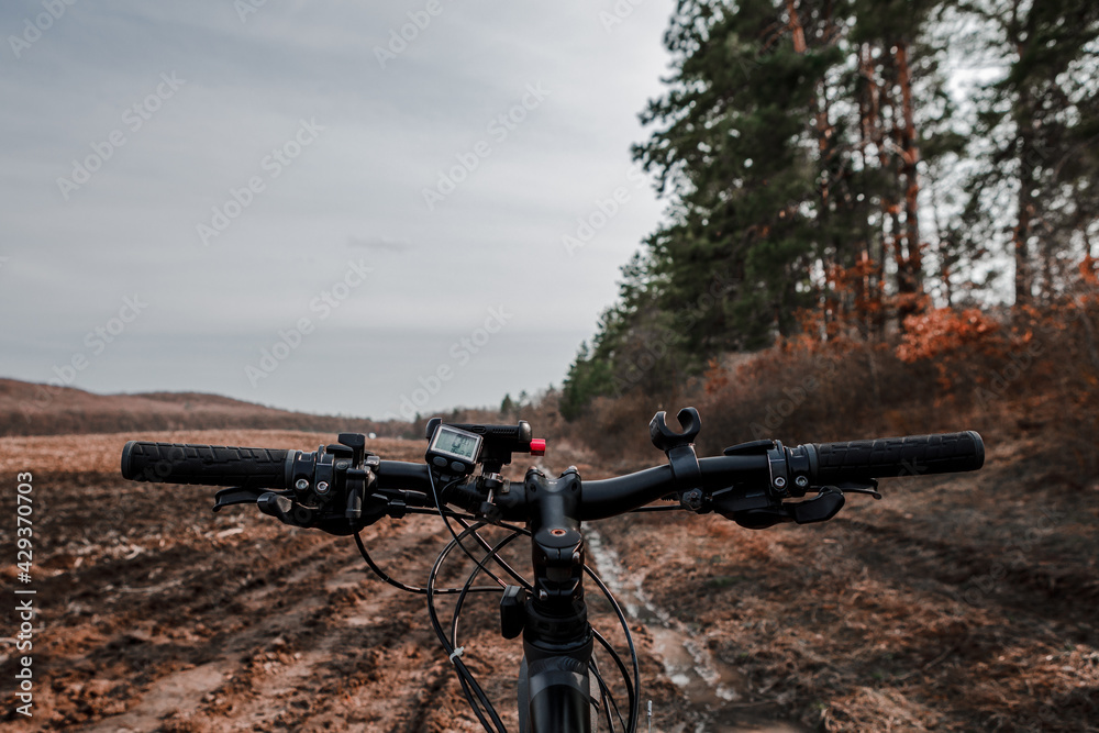 Bicycle on the field road. View from bikers eyes. Bicycle on the field road. View from bikers eyes.
