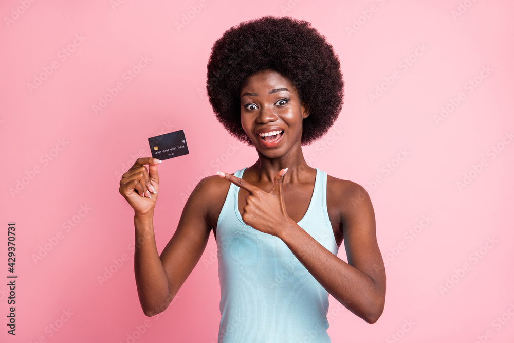 Photo of impressed nice brunette curly lady hold point card wear blue top isolated on pastel pink color background Photo of impressed nice brunette curly lady hold point card wear blue top isolated on pastel pink color background