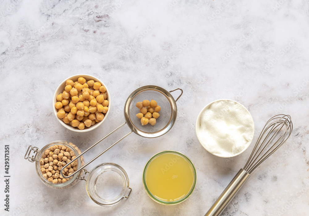 Canned chickpea aquafaba. Egg replacement and substitutes. Vegan cooking concept. whipped foam in a bowl. Top view, copy space. Canned chickpea aquafaba. Egg replacement and substitutes. Vegan cooking concept. whipped foam in a bowl. Top view, copy space.