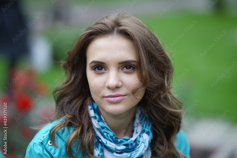 Portrait of a young beautiful girl in the park