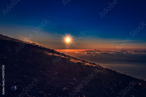 Sunset in the mountains over the clouds 
