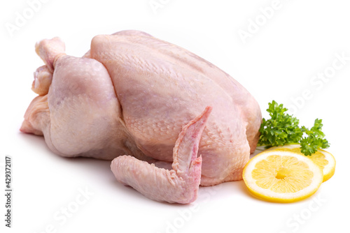 Raw chicken, lemon wedges and a bunch of parsley. Isolate on white background 
