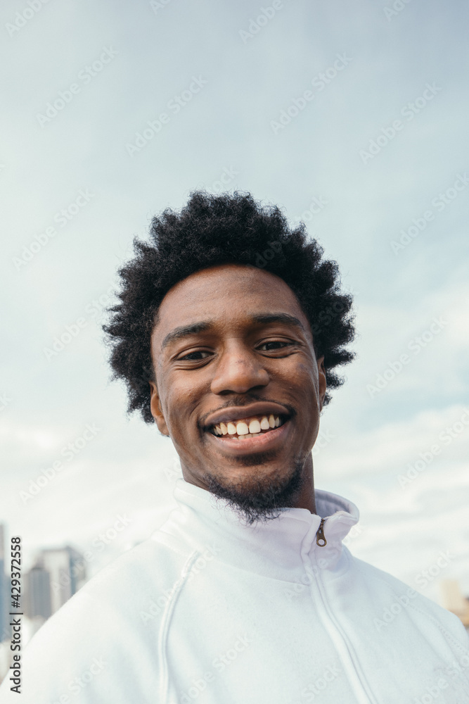 Young man with afro smiling