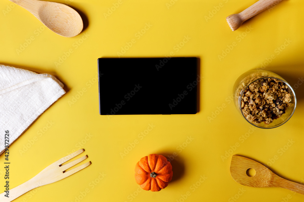 Flat lay with tablet with black mockup and place for text on yellow background. Food blogger's workplace. Culinary blog, recipe template, online cooking courses. Healthy food concept. Copy space. Flat lay with tablet with black mockup and place for text on yellow background. Food blogger's workplace. Culinary blog, recipe template, online cooking courses. Healthy food concept. Copy space.
