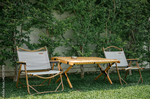 table and chairs in the garden © ArdichawatSripaiboo