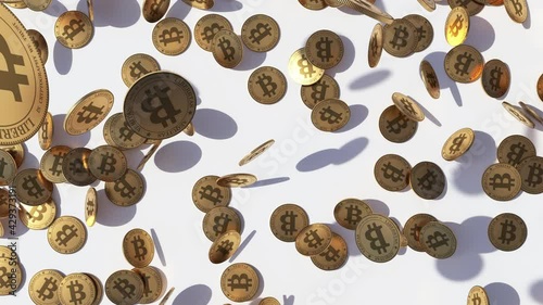 Animated flow of bitcoins that fall from the top on a white surface. 3D image of the flow of bitcoin coins, which fall to the surface, covering it.  The concept of money flow. 
