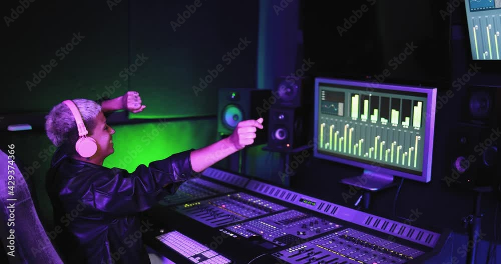 Musician and sound female engineer mixing new album inside boutique recording studio - Technology and music industry concept