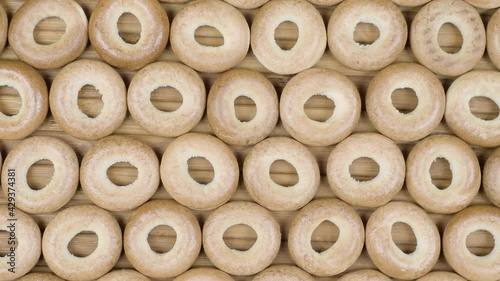 Drying or mini round bagels on wooden background. Top view. Donut snack
